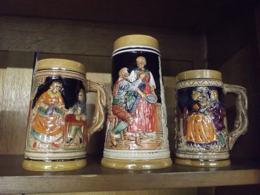 chopes anciennes Trois chope en céramique décorées de scènes folkloriques colorées.